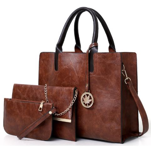 Image of a brown three piece purse set including a Large Tote Bag with handles and shoulder strap, a Clutch Bag mid-size bag (with chain strap) and a Wallet sized accessory bag