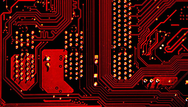 A close up image of a red computer chip.