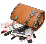 Image of a brown snakeskin leather purse bag with its contents spilling out of the bag