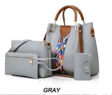 Image of a gray four-piece purse set with tribal print trim, including a large tote Bag, a large shoulder bag, a wallet-sized accessory bag, and a cardholder wallet. 