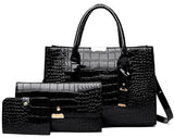 Image of a black Alligator skin tote bag, clutch, and small wallet standing side by side