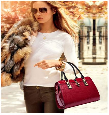 Image of a women walking with her red designer crocodile patent leather handbag.