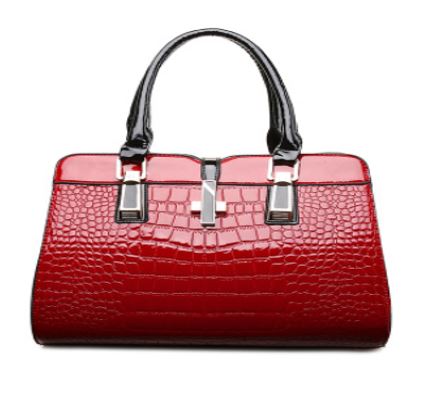 Image of a women's red designer crocodile patent leather handbag.